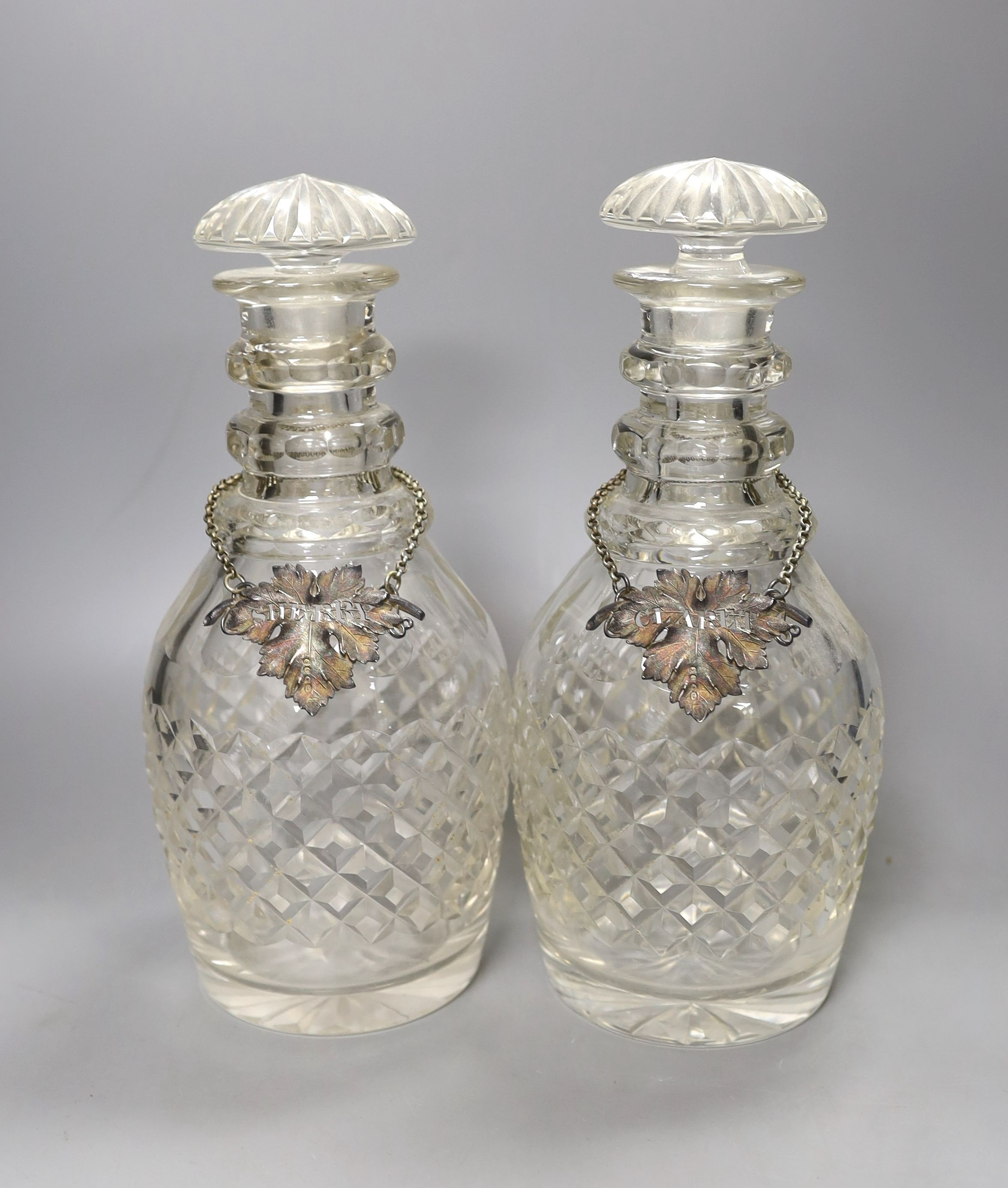 A pair of cut glass decanters with stoppers and Victorian silver ‘sherry’ and ‘claret’ labels, Reily & Storer, London, 1844, - 27.5cm high